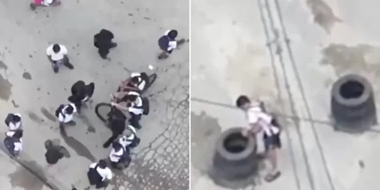 Drone flagra alunos com traficante de fuzil e ajudando a erguer barricadas